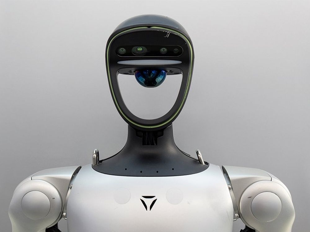 The Unitree humanoid robot with sleek design, dual-arm, and sensor-equipped head.